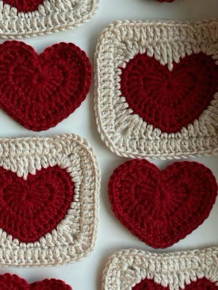 crocheted heart coasters arranged on top of each other in red and white