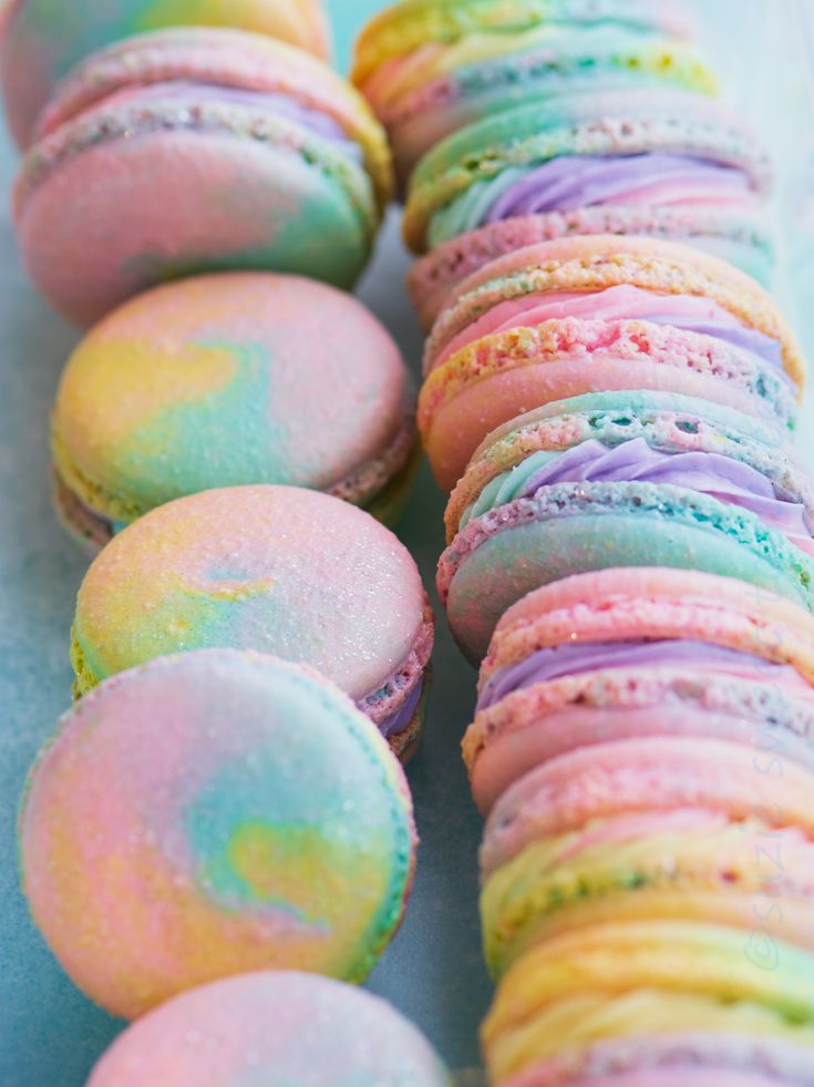 colorful macaroons are lined up on a table