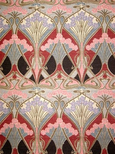 an intricately designed wallpaper with red, blue and pink colors on it's surface