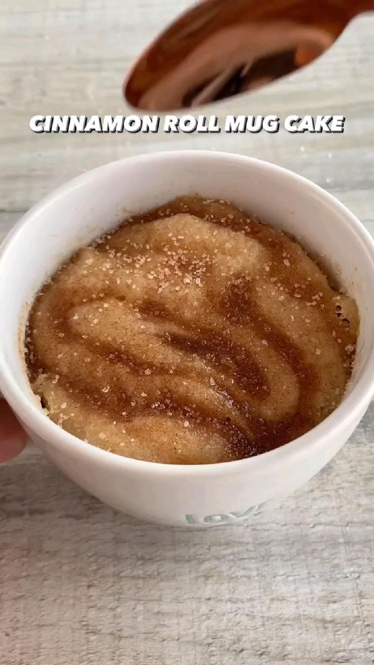 cinnamon roll mug cake in a white bowl