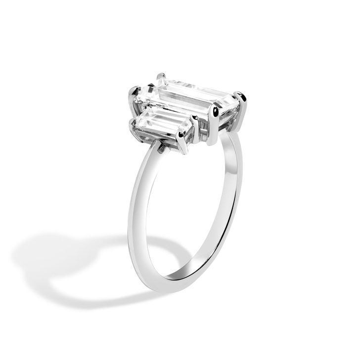 The 2020s engagement ring series is about restraint and paring down the unnecessary, leaving behind only what is the most important. The 3-Stone series, gives a nod to deco design, reimagined for the 2020s. Shedding excess details, our signature soft knife edge draws the eye to the trio of carefully balanced diamonds in each ring. Set low and flush to the finger, the 3-stone setting is designed with comfort in mind. Claw-set baguette center is flanked by a set of .40 carat baguette diamonds. Set Luxury Three Stone Baguette Cut Rings, Luxury Solitaire Baguette Cut Ring, Modern Platinum Rings With Baguette Diamonds, White Gold Baguette Cut Ring For Proposal, Timeless Baguette Cut Ring With Polished Finish, Luxury Baguette-cut Diamond Ring For Proposal, Platinum Three Stone Ring With Baguette Cut, Platinum Three-stone Ring With Baguette Cut, Platinum Three Stone Baguette Cut Ring