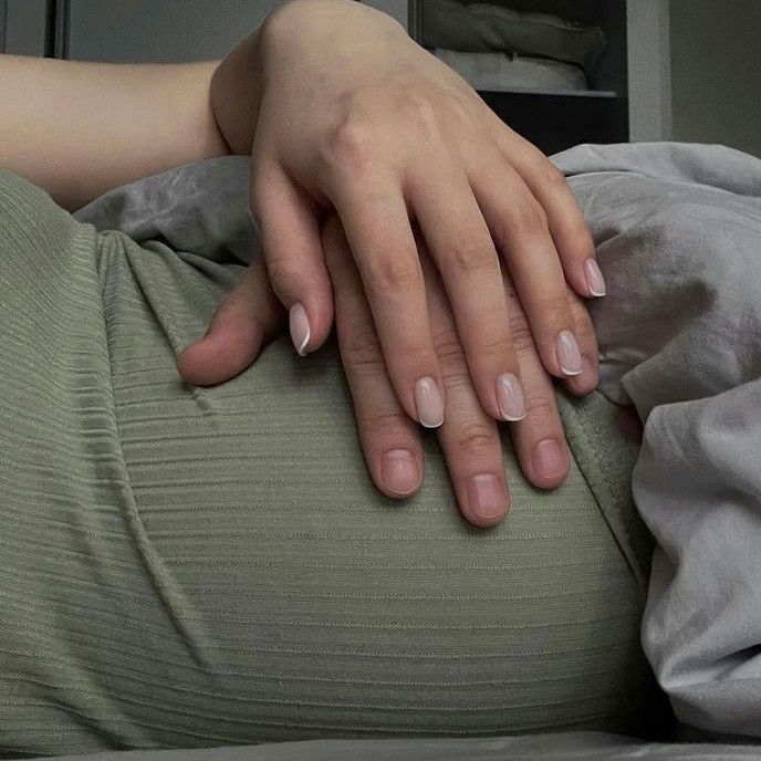 a woman's hands resting on her stomach