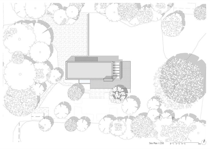 an aerial view of a house with trees and bushes