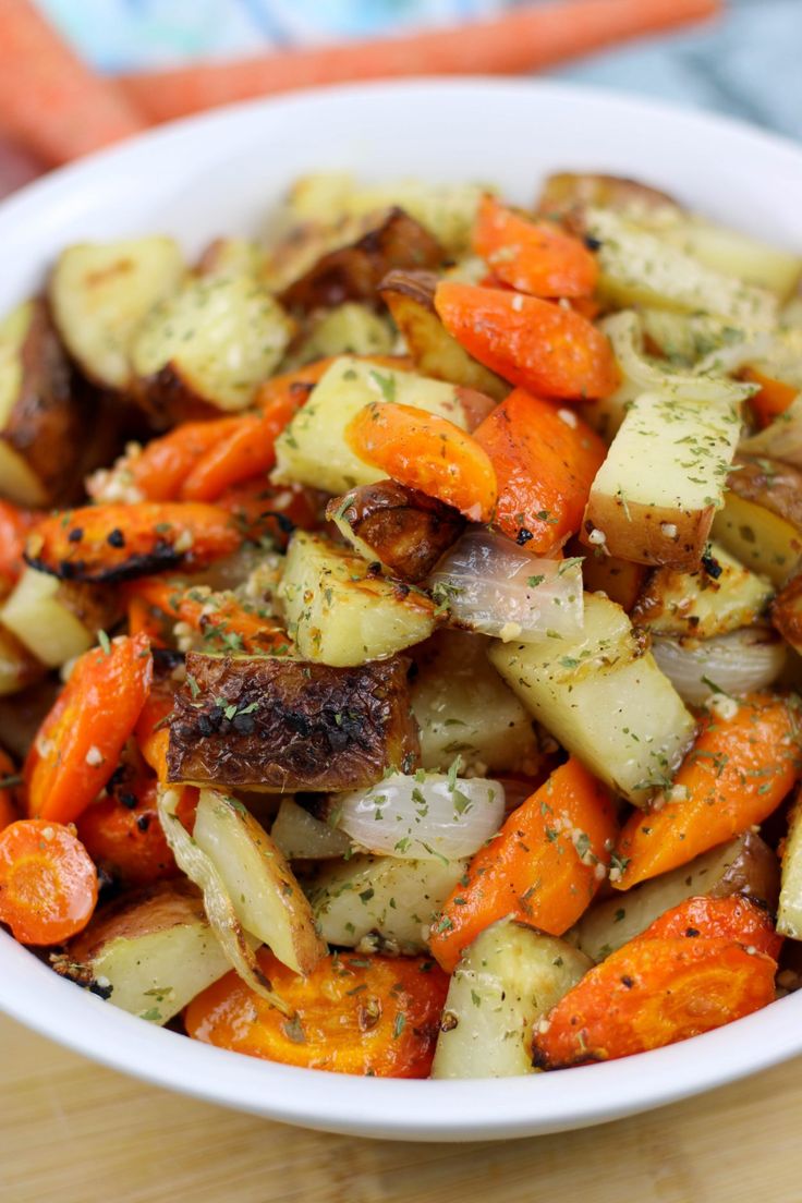 a white bowl filled with carrots and potatoes