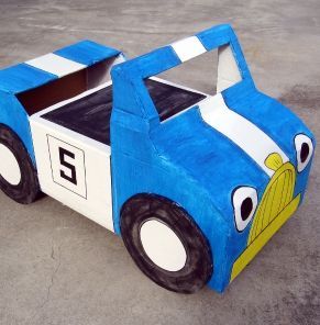 a cardboard car that is painted blue and white with the number 3 on it's side