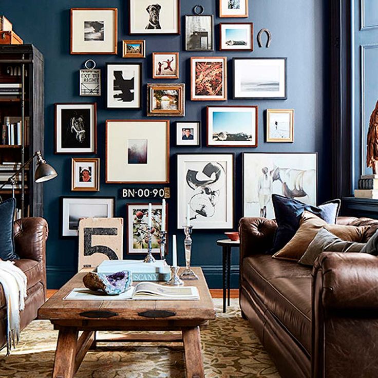 a living room filled with lots of furniture and pictures on the wall above it's coffee table