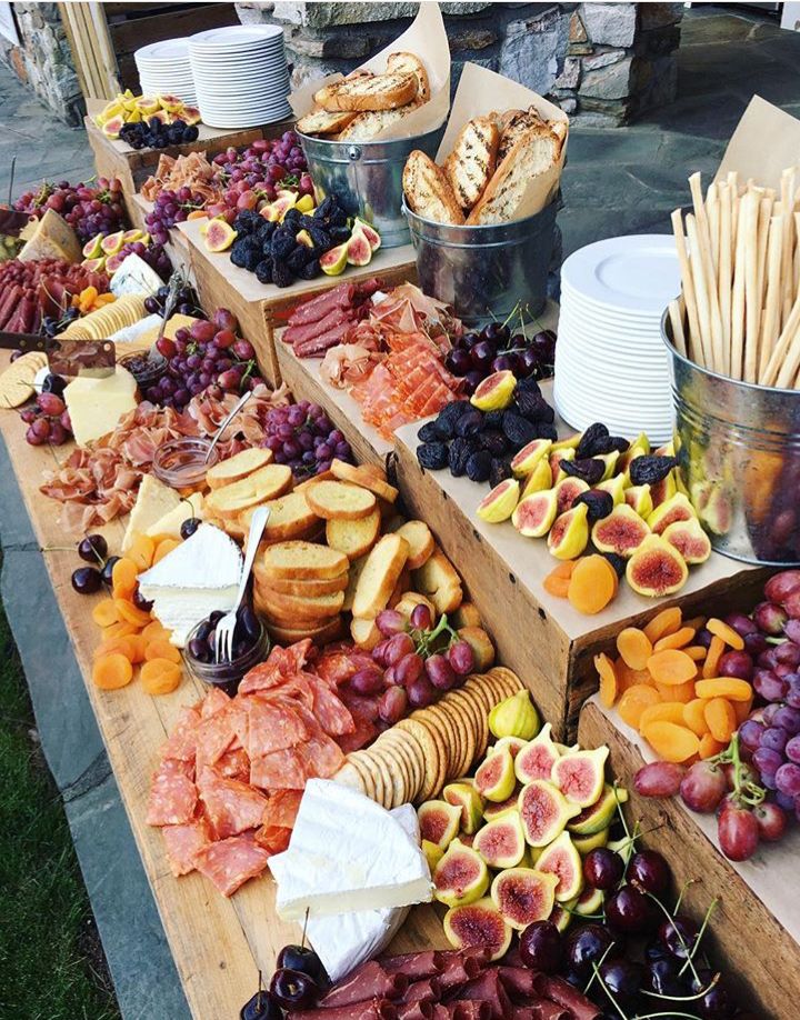 a table filled with assorted fruits and breads on it's sides for sale