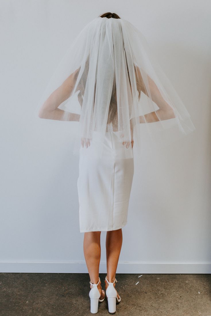 the back of a woman wearing a veil and shoes