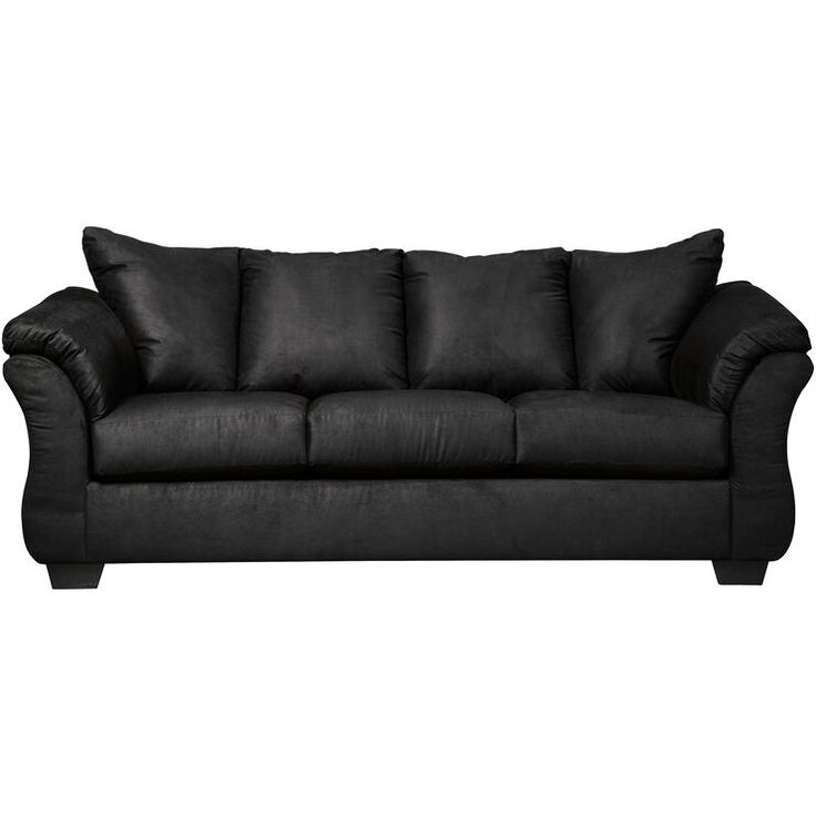 a black couch sitting on top of a white floor