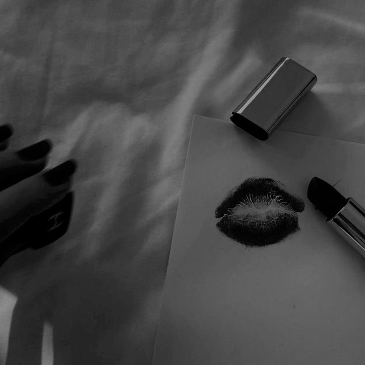 a black and white photo of lipstick on a piece of paper