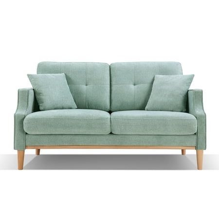 a light blue couch with pillows on it's arms and back cushions, sitting in front of a white background