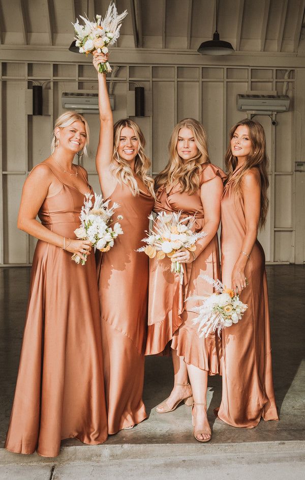 the bridesmaids are holding their bouquets up in the air