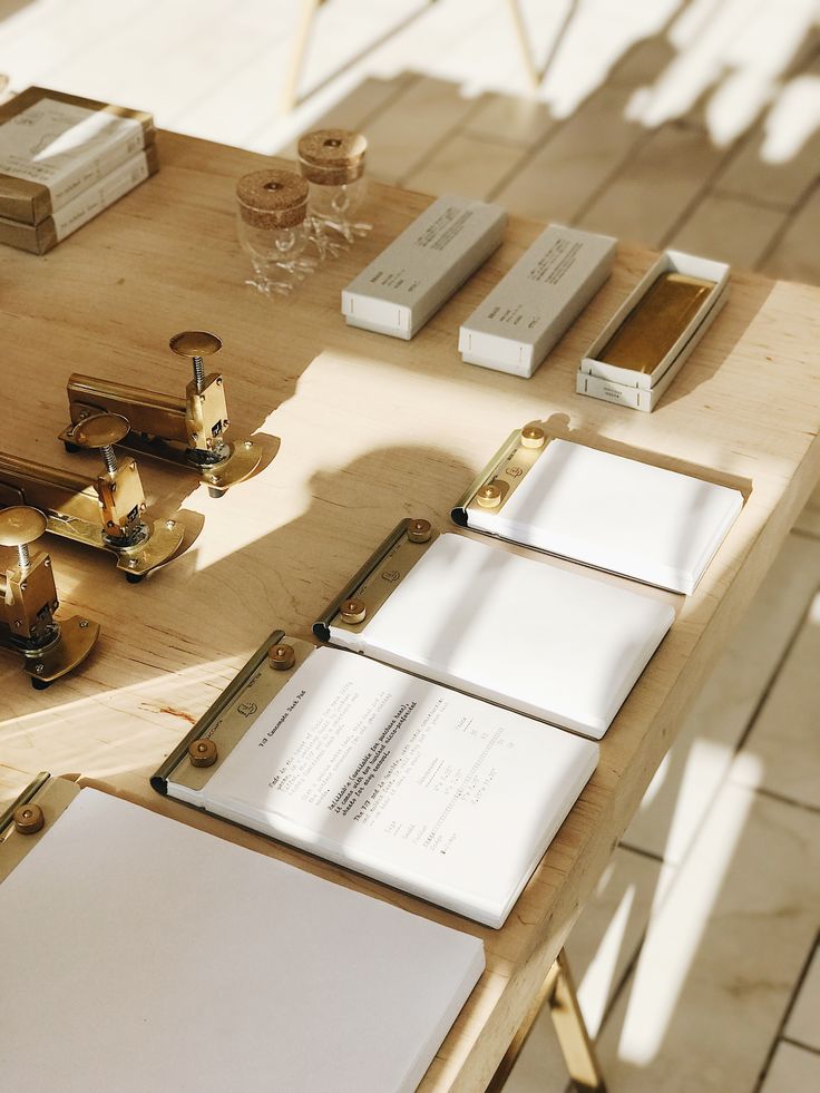 a wooden table topped with lots of books