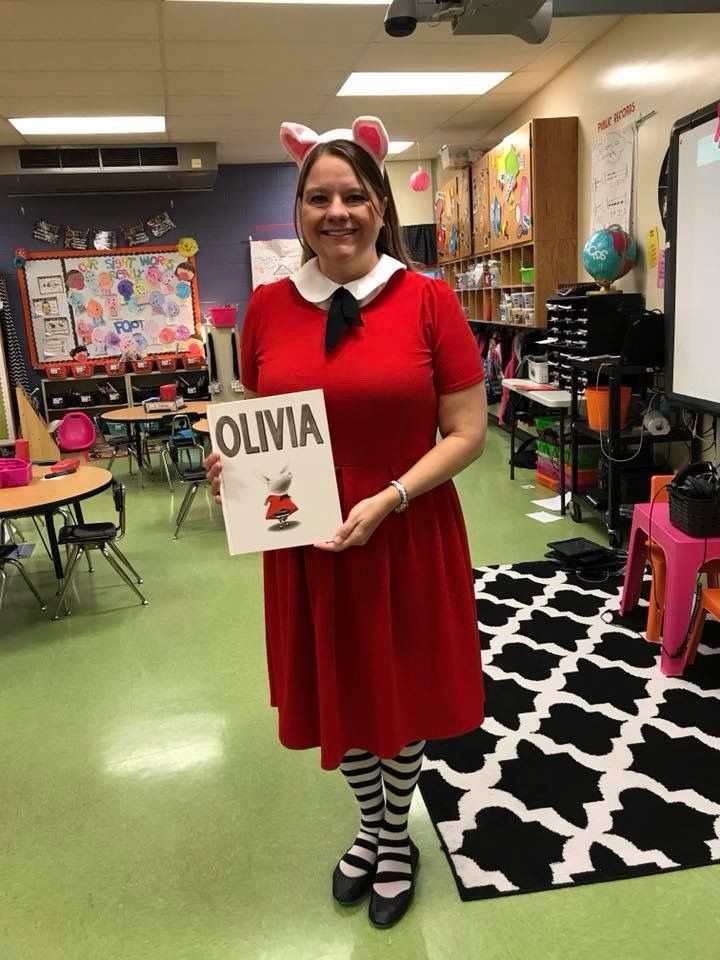 a woman in a red dress holding up a sign