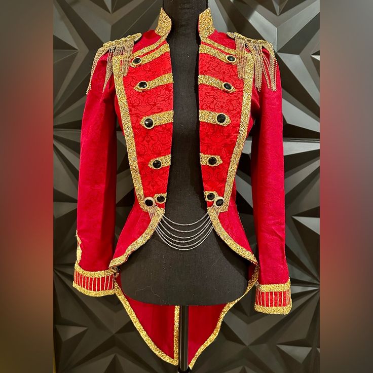 a red and gold uniform on display in front of a black background