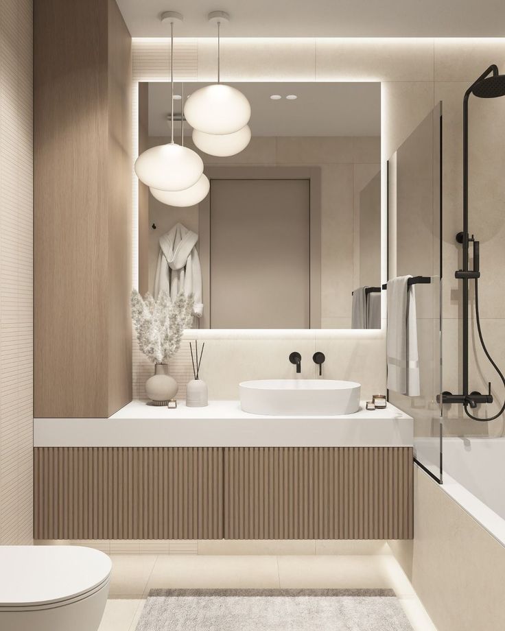 a bathroom with a sink, toilet and bathtub next to a shower head mounted on the wall