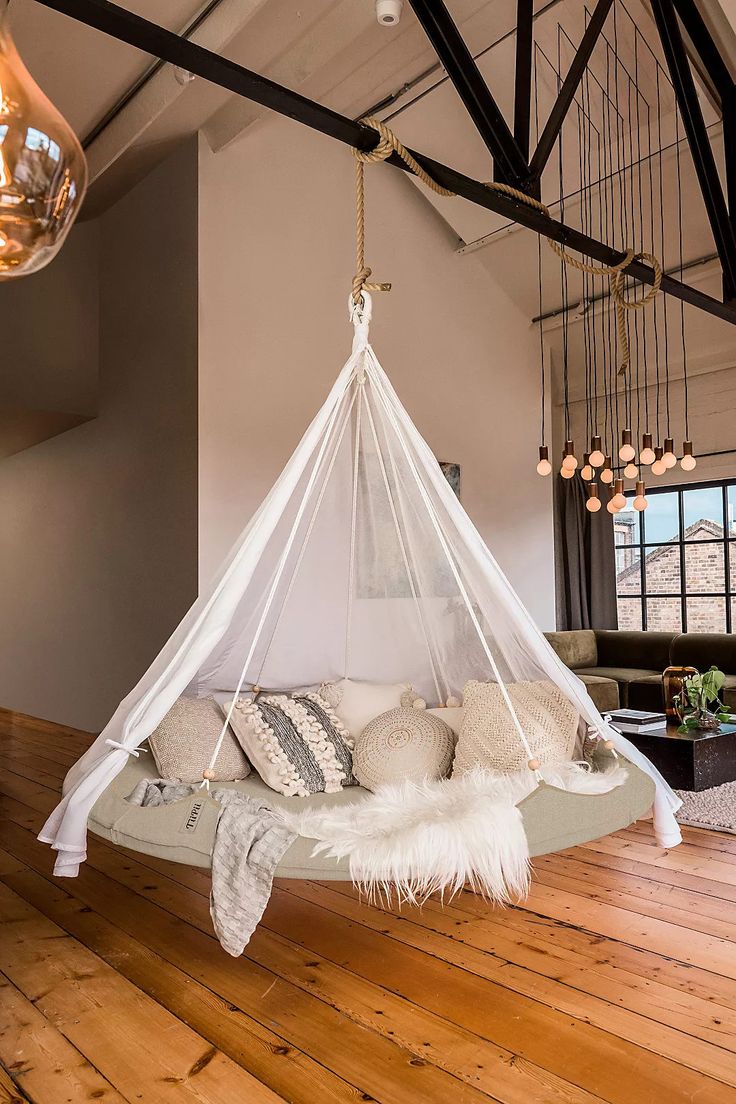 a hanging bed in the middle of a living room