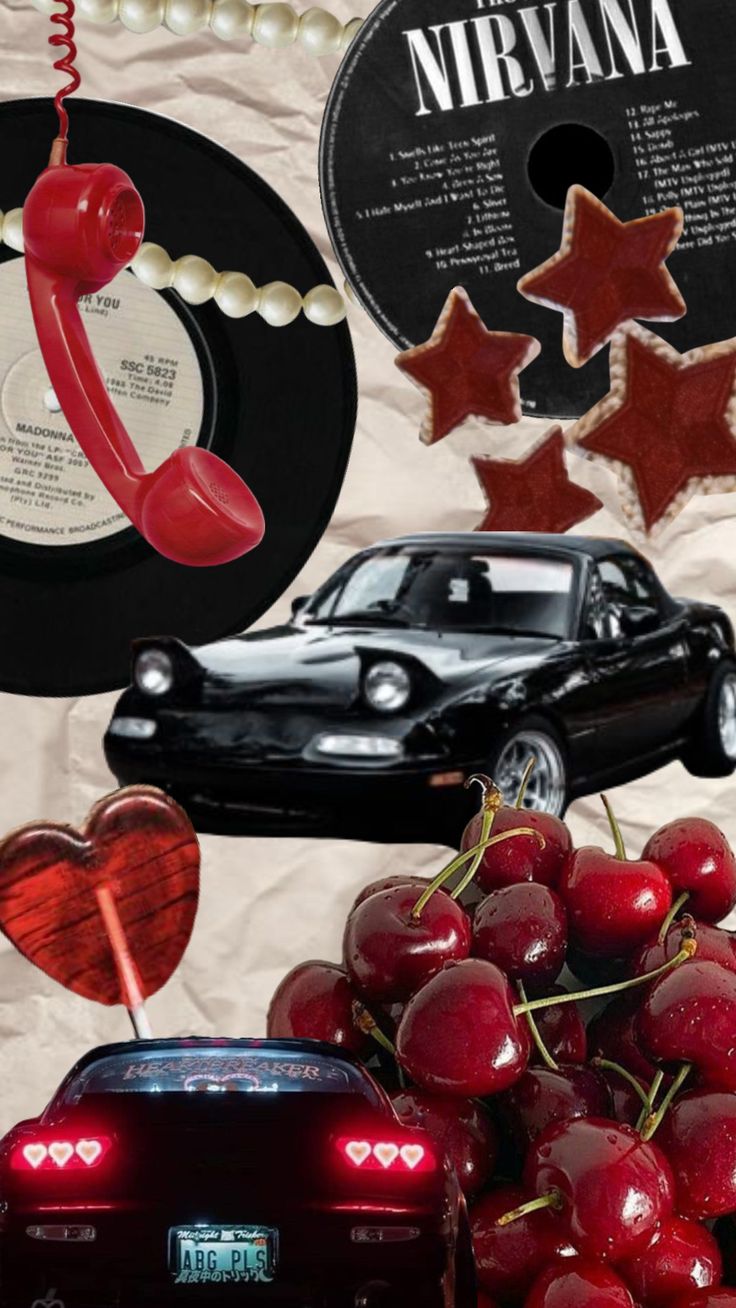 a bunch of cherries sitting on top of a table next to a black car