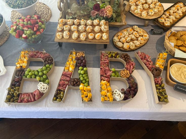 a table topped with lots of different types of food next to the word bake