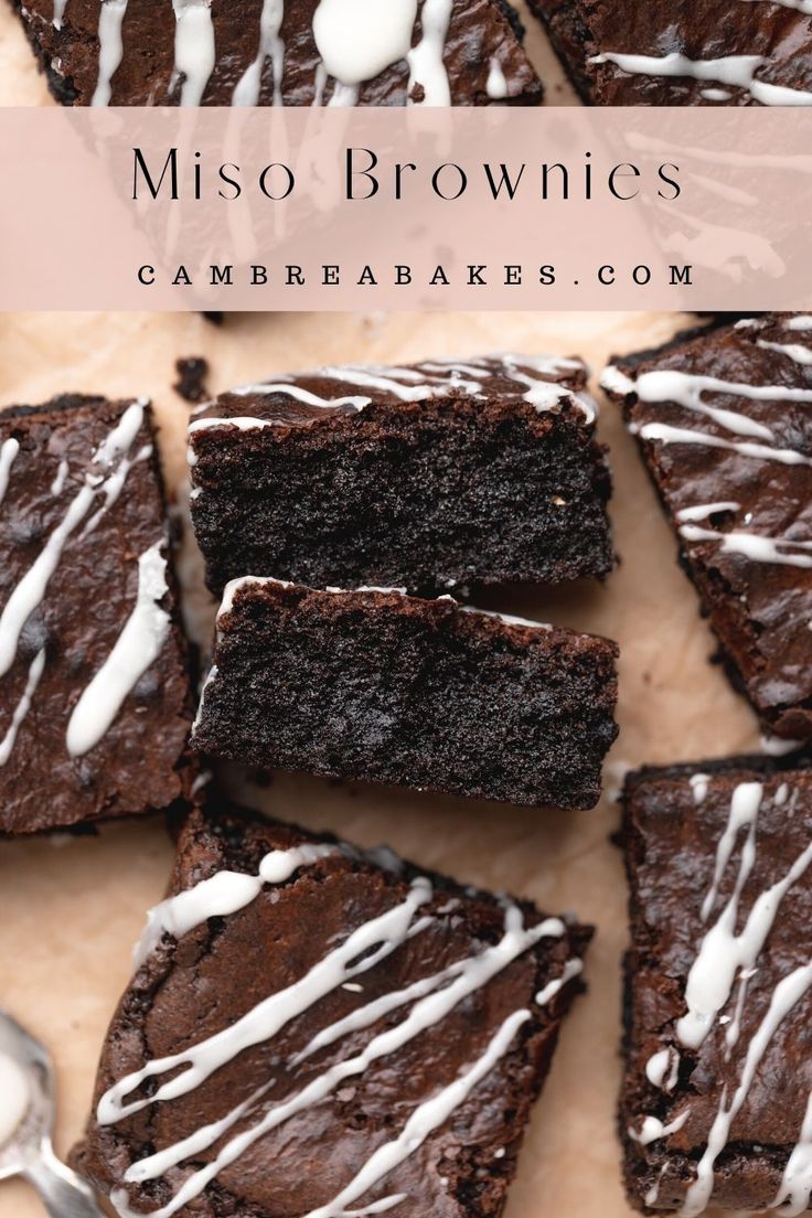 chocolate brownies with white icing are on a cutting board