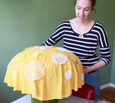 a woman standing in front of a table with a yellow object on top of it