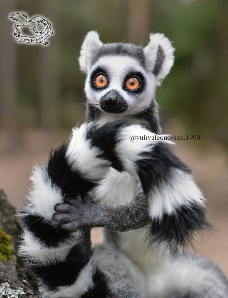 a stuffed animal sitting on top of a tree branch