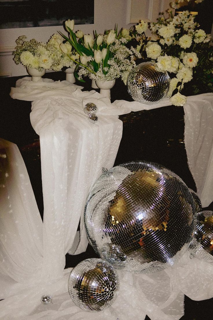 disco balls and flowers are on the table