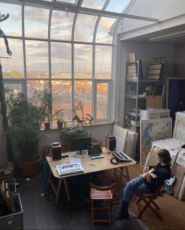 a man sitting in a chair next to a window