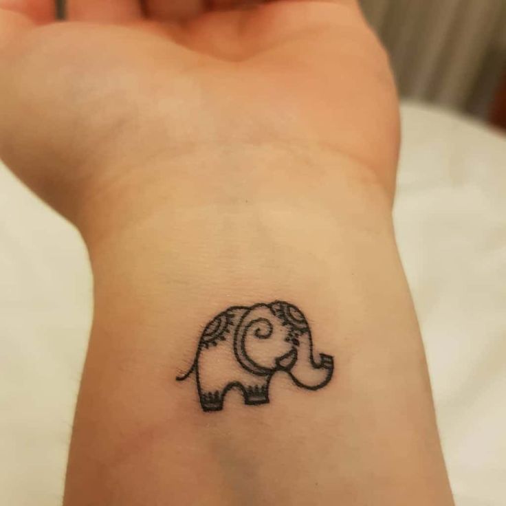 an elephant tattoo on the wrist