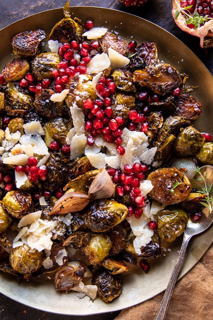 a plate filled with brussel sprouts and pomegranates