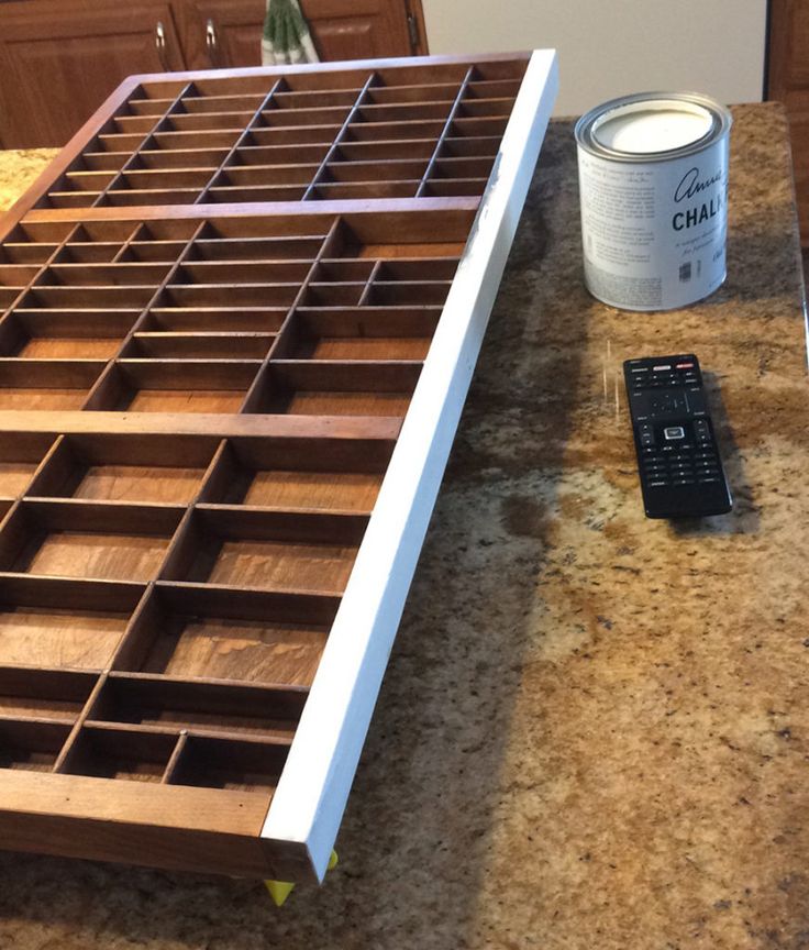 a can of paint sitting on top of a counter next to a drawer with drawers