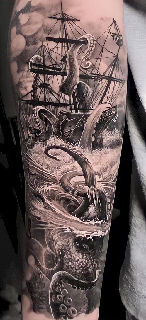 a man with an octopus and ship tattoo on his arm in black and grey ink