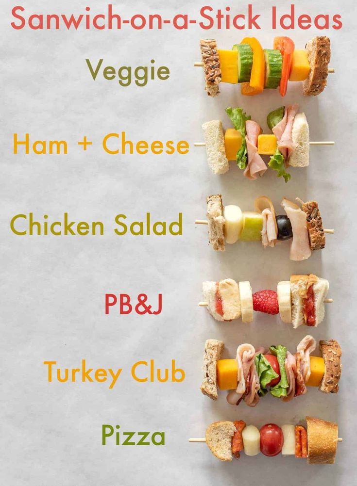 several small sandwiches are arranged on skewers with cheese, ham, chicken salad and turkey club