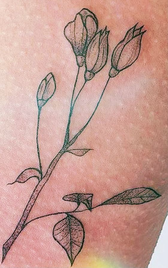 a close up of a person's arm with flowers on it