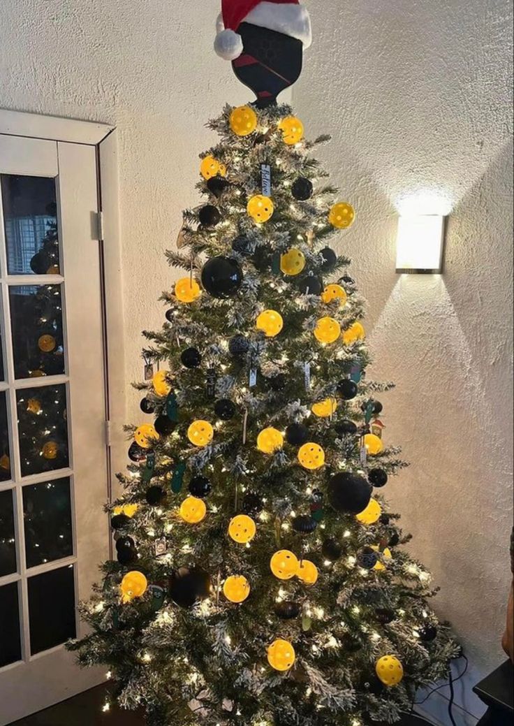 a decorated christmas tree with yellow flowers on it