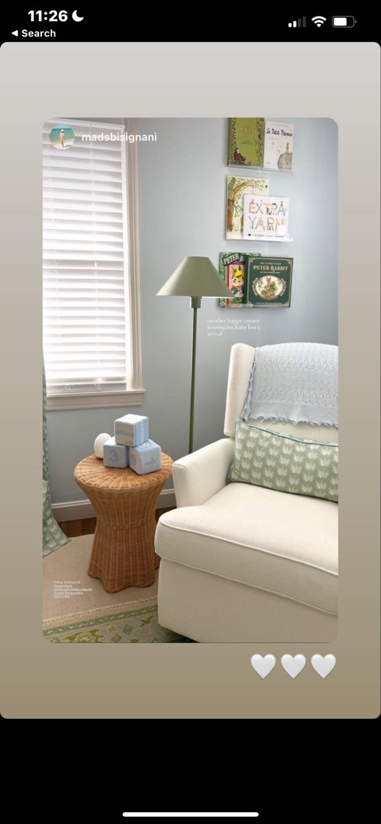 a living room filled with furniture and a lamp on top of a wooden table in front of a window