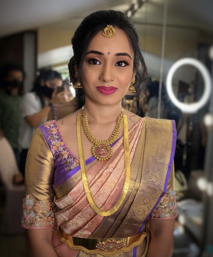 a woman in a sari is posing for the camera