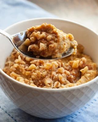 a white bowl filled with oatmeal on top of a blue table cloth