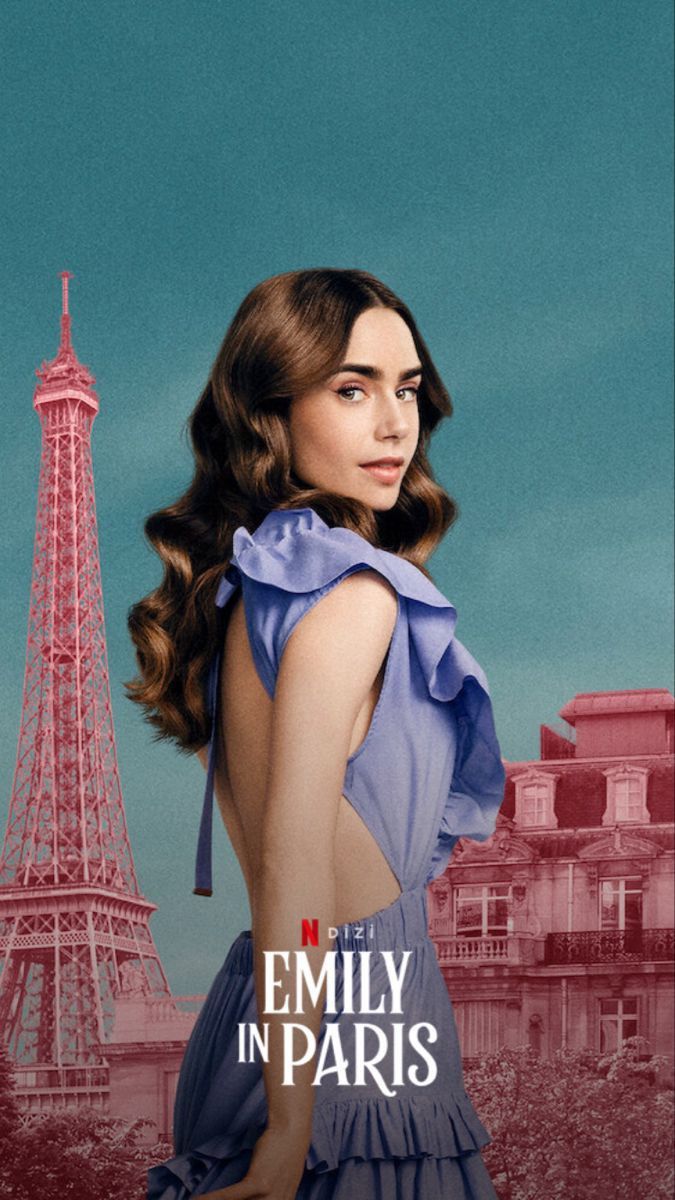 a woman in a blue dress standing next to the eiffel tower with her hands on her hips