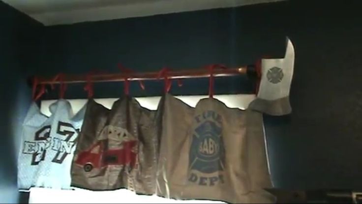 several bags hanging on a rack in a room