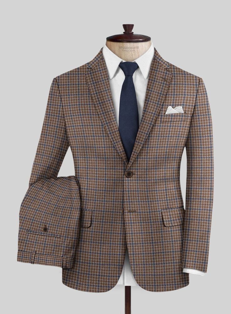 On the hunt for a timeless and fashionable suit that guarantees you'll turn heads? Look no further than our Reda Baez Brown Checks Wool Suit. Crafted from pure wool, it gives you natural warmth and unparalleled comfort, showcasing meticulous craftsmanship. This classic suit is your ticket to making an impression at any event in a professional or social setting.  Look Includes    Reda Baez Brown Checks  Wool  Fabric  Two Button Jacket Style  Notch Lapel   Horn   Brown  Buttons  Single Vent  Three Wool Three-piece Suit With Welt Pockets For Winter, Wool Three-piece Suit Single Breasted, Fitted Brown Double Breasted Suit For Fall, Wool Suit With Suit Collar For Fall, Wool Suits With Suit Collar For Fall, Custom Fit Single Breasted Suits For Winter, Brown Wool Three-piece Suit For Fall, Fitted Wool Three-piece Suit With Long Sleeves, Fall Wool Suit With Suit Collar