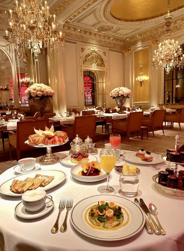 a fancy dining room set up with plates and silverware for two people to eat