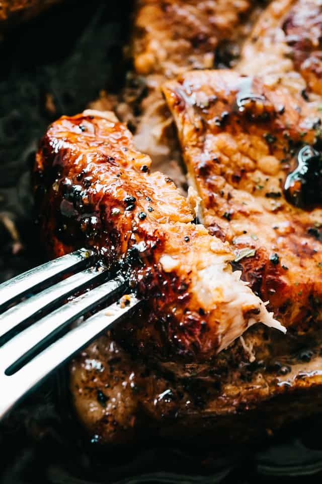 a fork is stuck into some meat on a plate