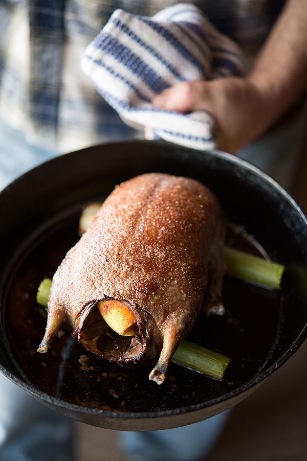 a person holding a pan with some food in it