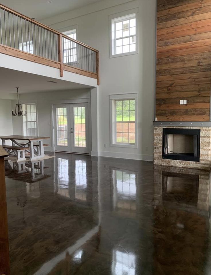 an empty living room with wood paneling on the walls and floor is pictured in this image