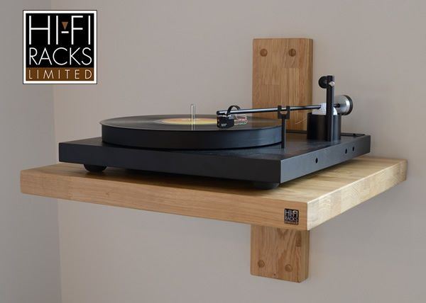 a record player sitting on top of a wooden shelf