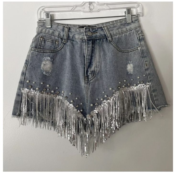 Denim Distressed Shorts From Shop Michella, Perfect For Any Cowgirl Or Western-Themed Occasion. The Shorts Feature A 5-Pocket Design And Button And Zip Closure, With Accents Such As Pearls, Fringe, Rhinestones, And Sequins. Medium Wash. New, With Tags. Perfect Condition. Trendy High Waist Jean Shorts For Parties, Trendy Cutoff Bottoms For Party, Summer Party Cutoff Bottoms, Spring Rhinestone Fringe Shorts, High Waist Jean Shorts For Spring Party, Spring Party Bottoms With Frayed Hem, Party Cutoff Denim Shorts, Spring Denim Shorts With Rhinestone Fringe, Denim Blue Jeans For Summer Night Out