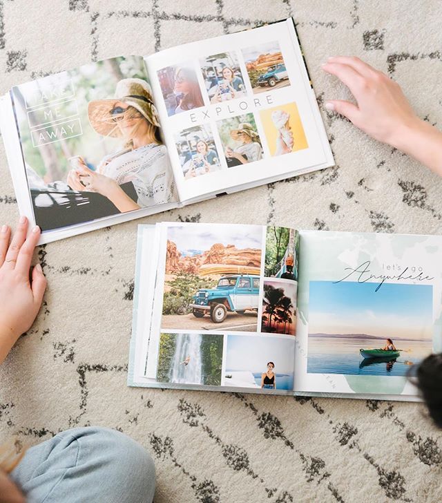 a person sitting on the floor looking at pictures in a book with their hands over them