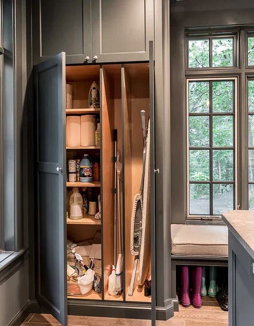 an open cabinet in the middle of a kitchen with lots of cupboard space and drawers