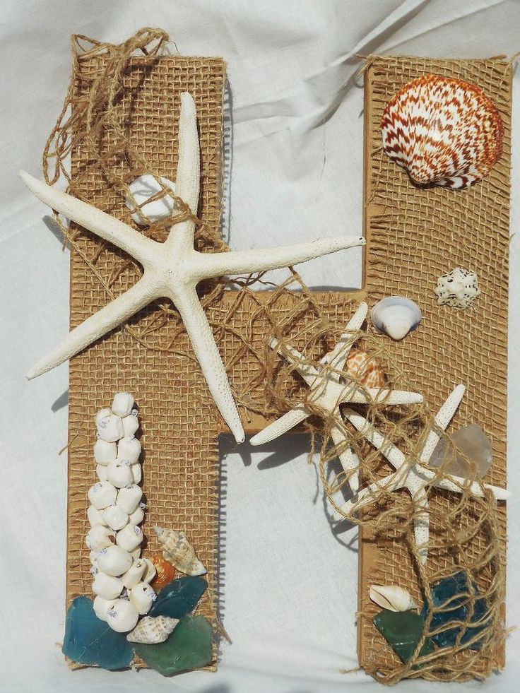 the letter h is made out of burlap with shells and seashells